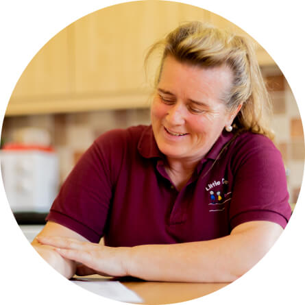 A learner reading in their kitchen
