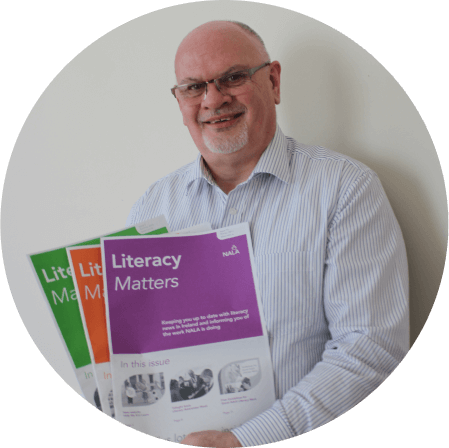 A person holding up learning resources