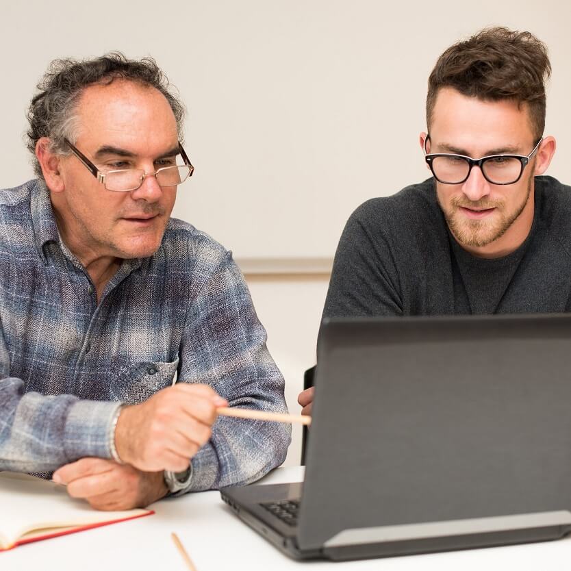 A tutor helping a learner using a computer