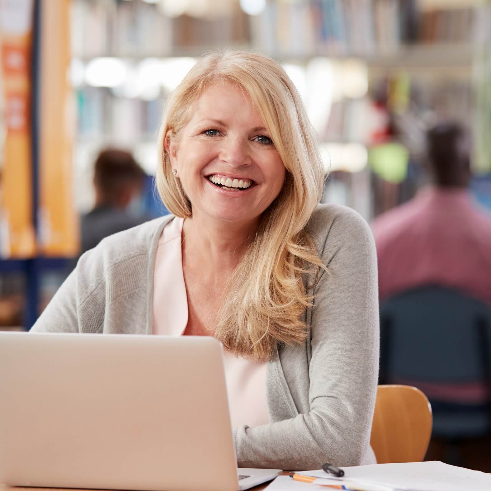 A person smiling and using a computer